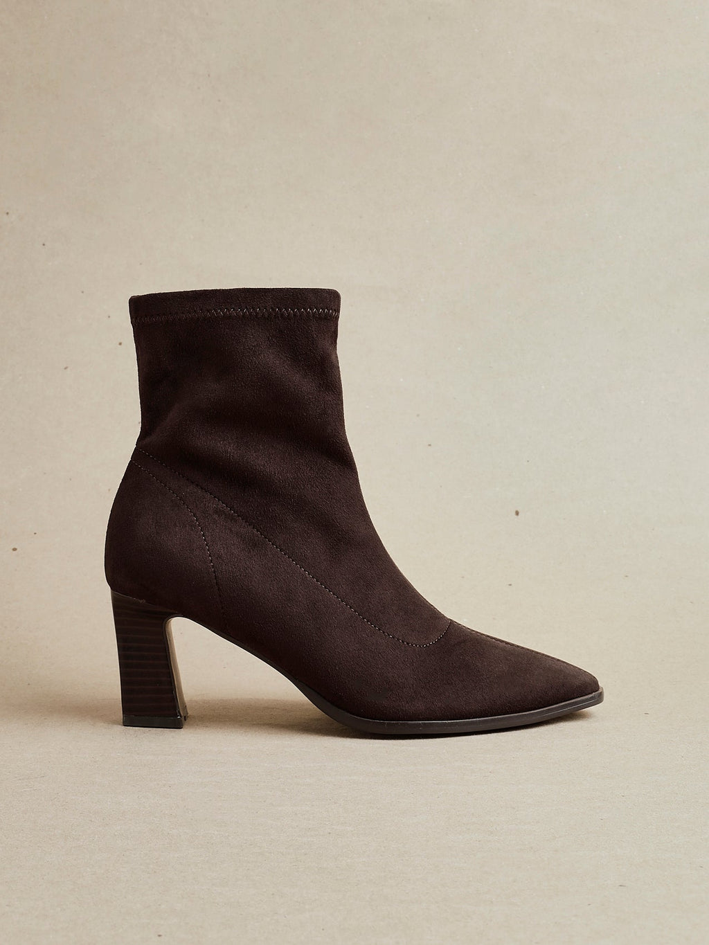 Brown ankle boot on a beige background